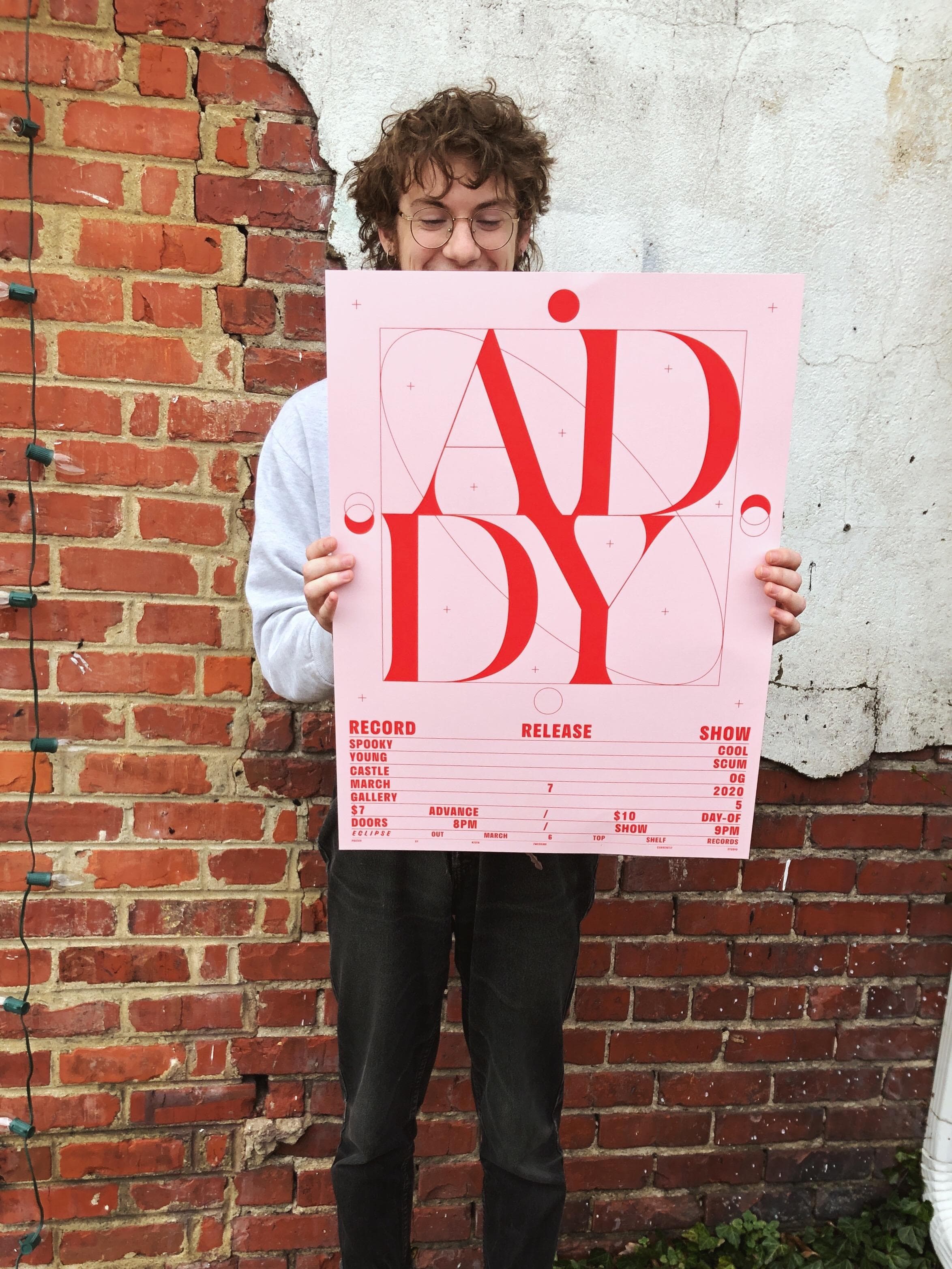 Addy holding the poster for their record release show